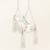 Baby Hammock Beige, in velvet, three-quarter view with tassels, wooden beads and padded seat