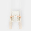 Indoor Swing For Toddler and Baby Beige, front view with quilted seat, wooden bar and tassels