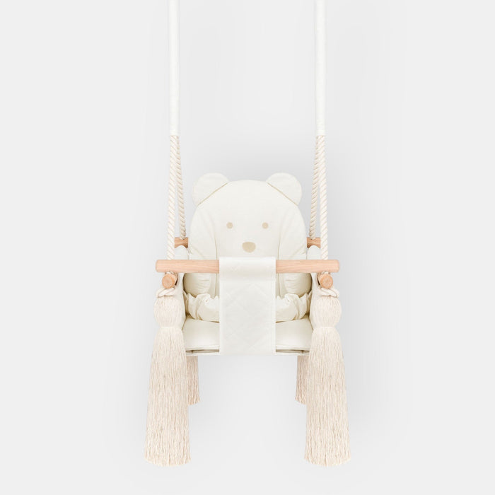 Indoor Swing For Toddler and Baby Beige, front view with quilted seat, wooden bar and tassels