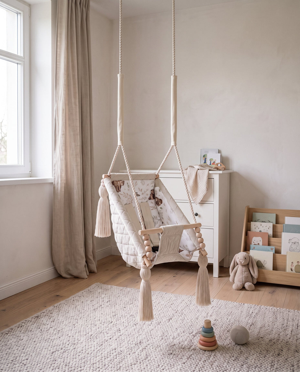 Quilted velvet baby hammock in beige with a soft insert in a nursery